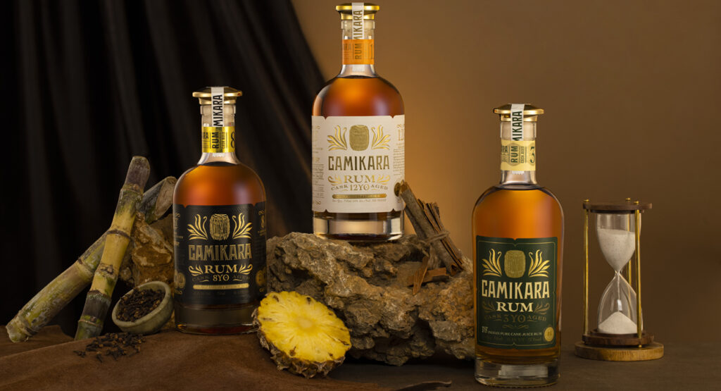 Camikara rum showcased at the Explorers Club, highlighting golden pours and signature cocktails in a celebration of India’s premium spirits.